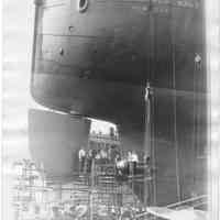 B+W photo of shipyard workers repairing the propeller of the S.S. American Merchant in dry dock, Hoboken, no date, ca. 1940.