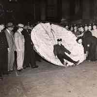 Digital image of b+w photo of Mayor Fred M. DeSapio et al at a Fire Dept. demonstration of safety net at City Hall, Hoboken, no date, ca. 1947-1951.