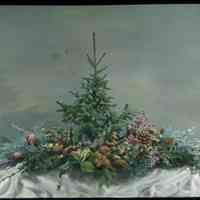Lantern slide, color, of a Christmas evergreen centerpiece with berries and pine cones, used for promotional display in Hoboken, no date, ca. 1920.