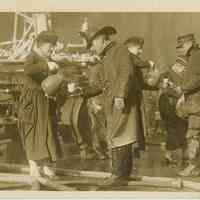 Sepia-tone photo of 2 Red Cross volunteers providing coffee to firemen at the Admiral Benson Club fire, Hoboken, Dec. 15, 1919.