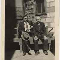 Digital image of B+W photo of Raffaele Gallo (right) seated with a man on bench in backyard of 509 Monroe St., Hoboken, no date, ca. 1920-1930.