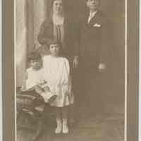 Sepia-tone photo portrait of an Italian family posed in a studio, Genova, no date, ca. 1915-1925.
