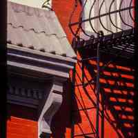 Color slide of detail view of cornice, dentils, bracket and fire escape on the 8th Street side of 800 Bloomfield on the NW corner of Bloomfield and 8th