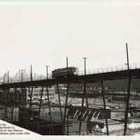 B+W photo of streetcar on elevated trestle in southwest Hoboken; Cocomalt & Davis Baking Powder sign, from Jersey City, n.d., ca. 1940s.