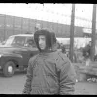 Color slide of unidentified man wearing a parka on pier set of the motion picture "On the Waterfront", Hoboken, no date, ca. late 1953-early 1954.