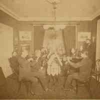 Digital image of sepia-tone photo of Antonio Jacobsen playing cello with other musicians in the parlor of 705 Palisade Avenue, W. Hoboken, 1889.