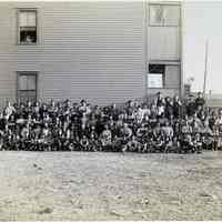          16 Newark(?), large group of workers posed outside housing
   