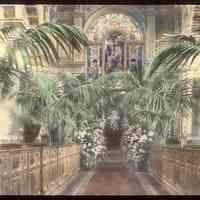 Lantern slide, color, of a church interior with floral decorations, used for promotional display in Hoboken, no date, ca. 1920.