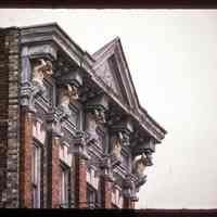 Color slide of close-up view of cornice, pediment, and figurine brackets at 712 Adams between 7th and 8th