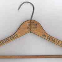 Wooden coat hanger stamped Angelo Falco, Clothier, 500 Grand St., Hoboken, N.J., ca 1950