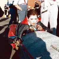 Color photo of the 1985 Hoboken Ragamuffin Parade with a child in vampire costume in a "coffin car", Hoboken, October, 1985.