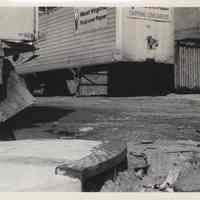 B+W photo of street corner sewer drain at 11th and Madison Streets with trucks in the background, Hoboken, no date, ca. 1970-1980.