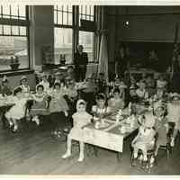 Digital image of b&w photo of elementary (kindergarten?) school class celebrating Thanksgiving at school; from the Giancaspro family of Hoboken, Hoboken, n.d., ca. mid-1950s.