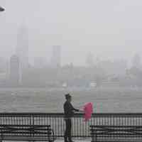          Superstorm_sandy_joe_epstein118; woman at waterfront with umbrella
   