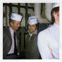 Digital image of color photograph of men inside Maxwell House Coffee plant wearing paper Maxwell House hats, Hoboken, Nov. 1973.