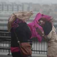          Superstorm_sandy_joe_epstein119; women near waterfront with umbrellas
   