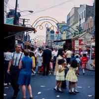 Color slide of people at a street fair/festival.