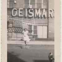 B+W photo of girl playing in 200 block of Bloomfield St. near back facade of Geismar