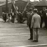          detail right center: officials in suits; Hudson Taxi Co. building
   