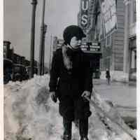 B+W photo of George A. Tompkins, Jr., ca. 5-7 years of age, shoveling snow near U.S. Theatre, Hoboken, winter, 1940.