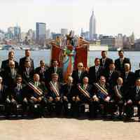          1: group posed at Hudson River waterfront with Madonna statue
   