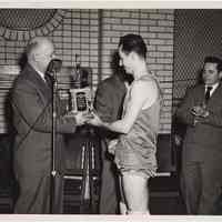 B+W photo of 1st place Industrial League basketball trophy to Lipton Tea at Hoboken YMCA, 1950.