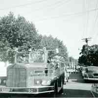 B+W photo of a Hoboken Fire Deparment fire truck in a parade, probably in Weehawken, no date, [1959].