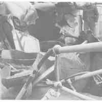 B+W photo of a worker surveying damage to unknown ship, Hoboken, no date, ca. 1940.