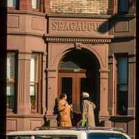          Color slide of close-up view of portico, bracket, dentils, bay windows and frieze reading 