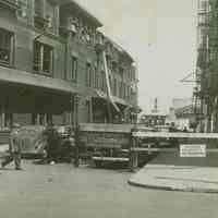 Color copy photo of a b+w photo of the street between the Hoboken Land Company building and 77 River St., Hoboken, no date, ca. 1945.