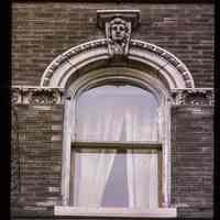          Color slide of close-up view of keystone, semicircular arch and decorative tile at 450 5th on the NW corner with Adams picture number 1
   