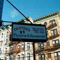 Color photo of hanging sign for Delfino