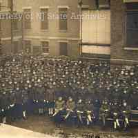 Digital image of sepia-tone exterior group photo of soldiers at U.S. Army Port of Embarkation, Hospital No. 1, Hoboken, no date, circa 1917-1920.