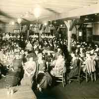 Sepia-tone group photo of a volunteers meeting at the Hoboken YMCA Hut, Hoboken, no date, ca. 1918-21.