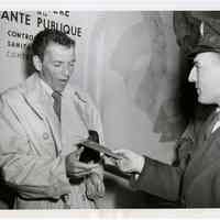 Sinatra photo: Frank Sinatra having passport inspected at customs in Paris, France, May 19 1950.