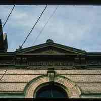          Color slide of detail view of pediment, cornice, brackets, frieze reading 