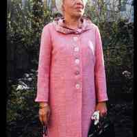 Color slide of a woman standing in a backyard.