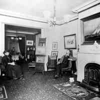 Digital black-and-white image of painter Antonio Jacobsen and wife Mary in their parlor, West Hoboken, no date, ca. 1890-1900.