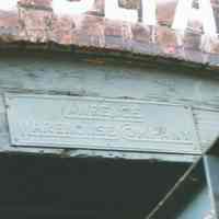 Color photo of the metal sign, Lawrence Warehouse Company, under the Receiving Entrance sign at 722 Grand St., Hoboken, Jan. 3 & 4, 2002.