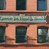 Color photo of a wall sign for Center for Family Health of St. Mary, 122-132 Clinton Street, Hoboken, Jan. 3 & 4, 2002.