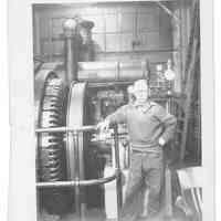 B+W photo of William Craig, photographer, inside a shipyard building, Hoboken, no date, ca 1935-1943.