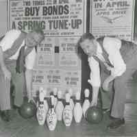 B+W photo of two Hudson County men at a bowling alley where caricatures of "Hitler & Co." were painted on pins, no place (Hudson County), [1943].