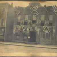 Sepia-tone photo of decoration by United Decorating Co. on building at unknown address, Hoboken, n.d., ca. 1910-1930.
