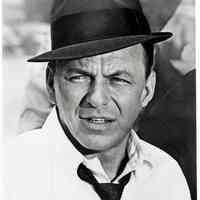 Black-and-white photo, movie still, of Frank Sinatra in 20th Century Fox film "Tony Rome" wearing trademark hat, no place, no date, ca. 1967.