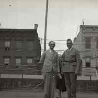 Digital image of B+W negative image of Julius & Anthony Durstewitz (Senior) and seven women (family?) on a roof, Hoboken. no date, circa 1938-1940.