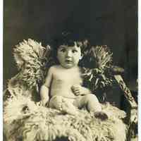 Sepia-tone photo of a baby posed in studio, Hoboken, n.d., ca. 1909.