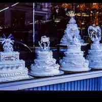 Color slide of wedding cakes in a bakery window.