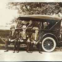 Digital image of sepia-tone photo four men with an automobile, no place, no date, circa 1923.