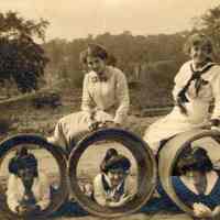 Sepia-tone photo of Florence & Madeline Miller with friends playfully posing on large pipes, no place, no date, ca. 1910-15.