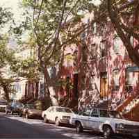 Color photo of street scene of houses and cars, Hoboken, July 1982.